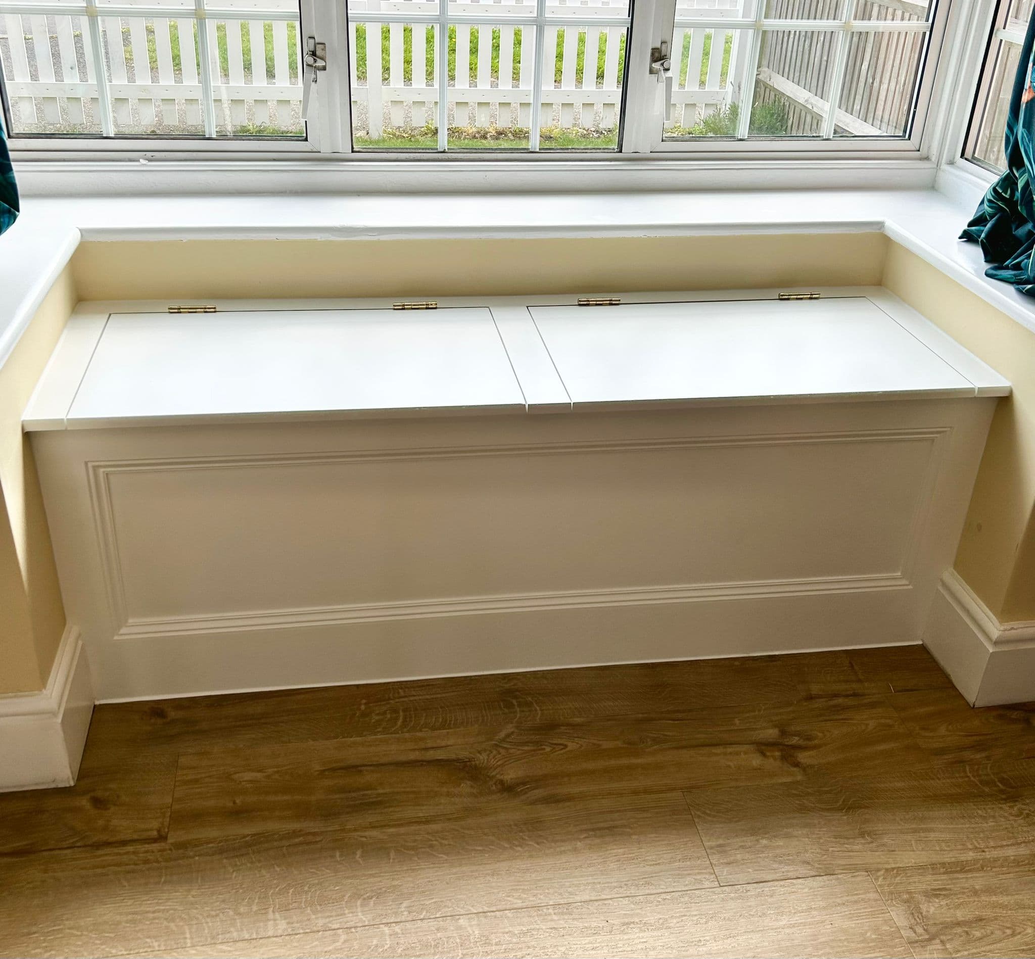 Custom window seat with storage and hinged panels