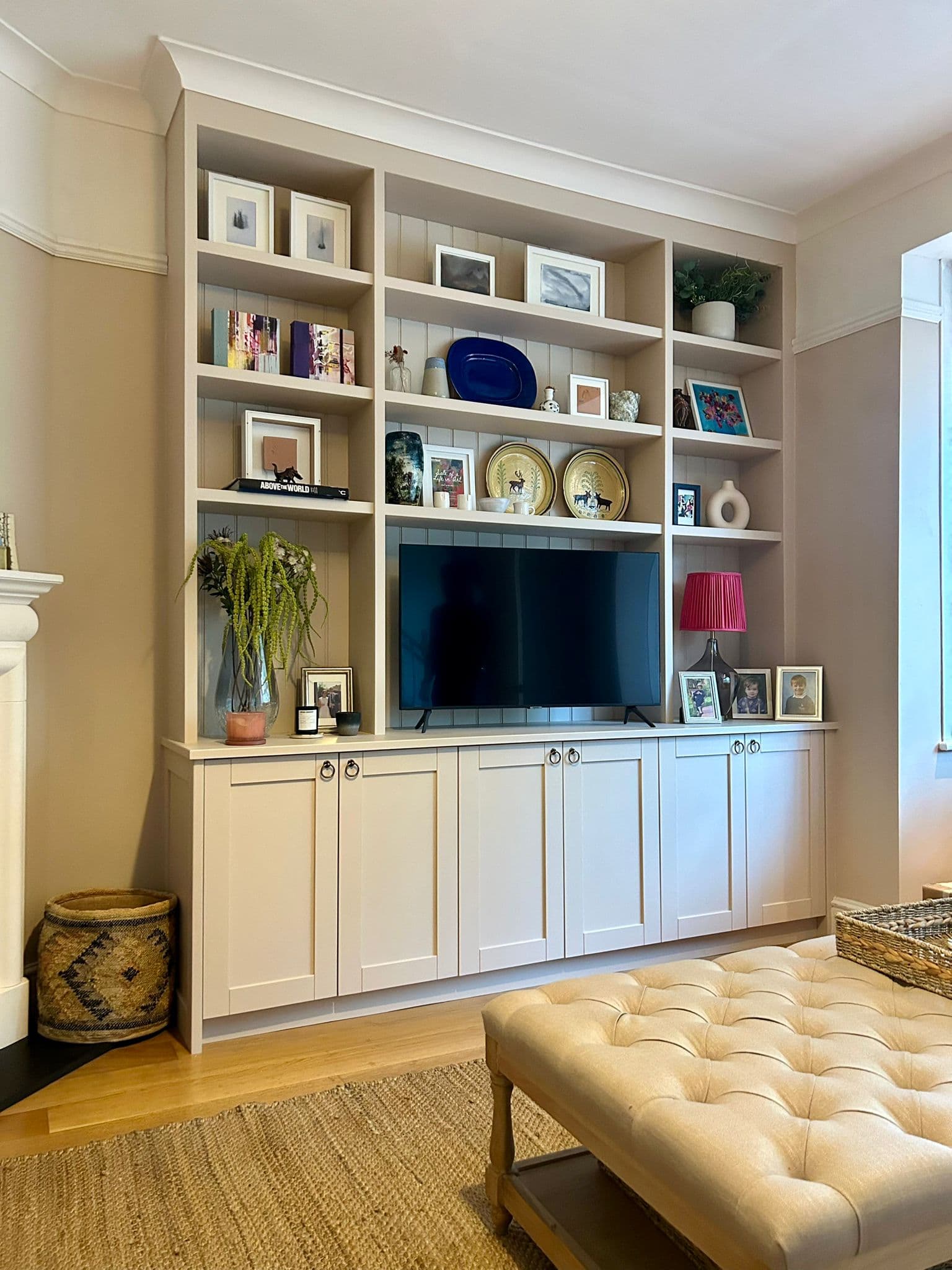 Custom built-in TV unit with shelving and storage, showcasing quality carpentry work